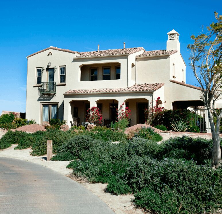 Spanish-style house with landscaped yard.